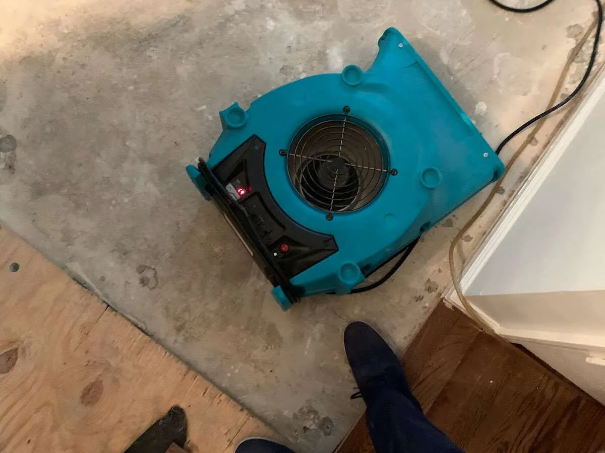 Air mover drying subfloor during Commercial Water Damage Restoration in North Mankato